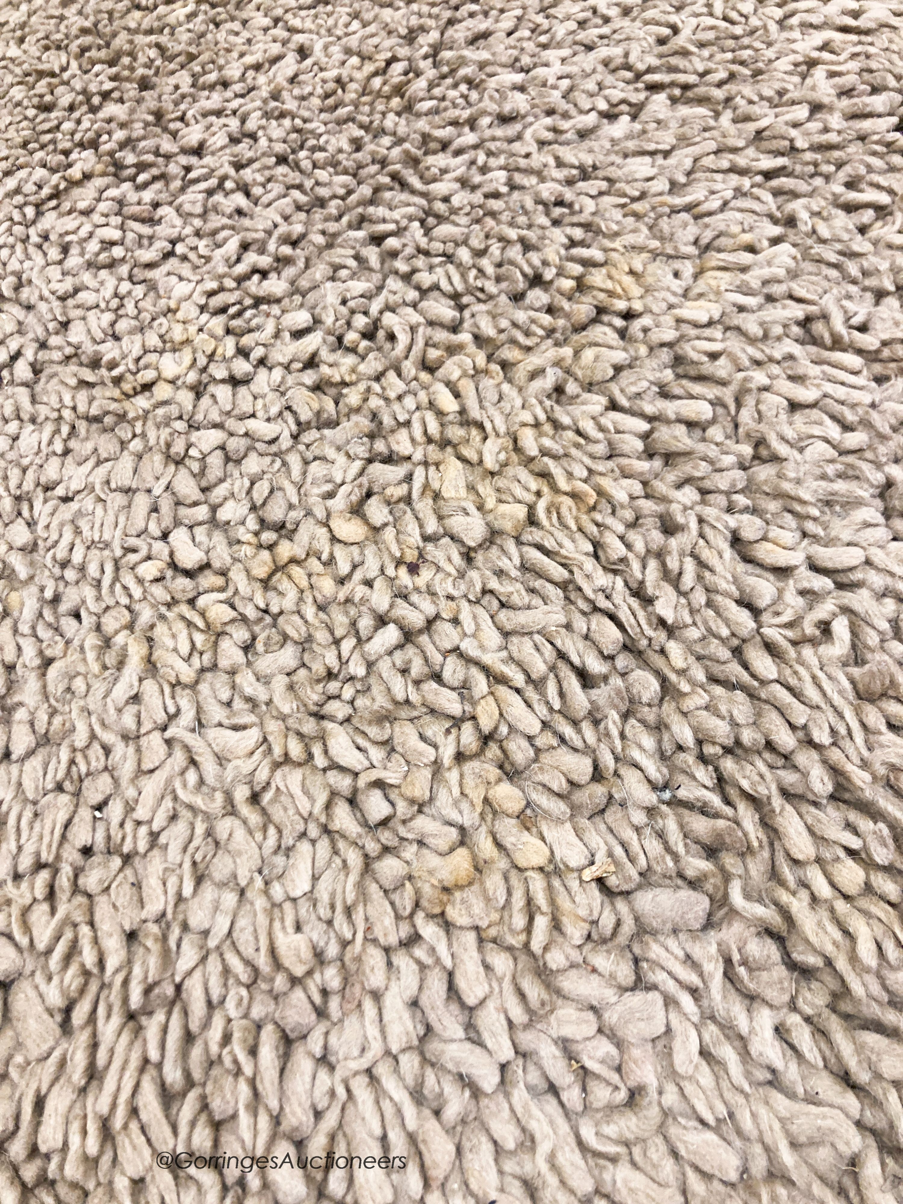 A contemporary brown shag pile carpet, 300 x 200cm
